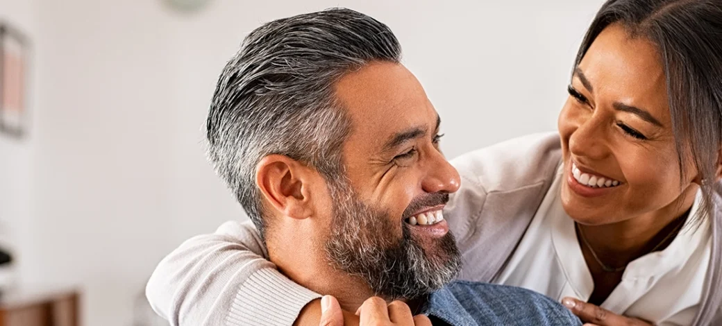 Egg donor recipient couple smiling at each other because egg donation is becoming the new normal.