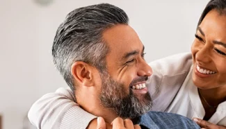 Egg donor recipient couple smiling at each other because egg donation is becoming the new normal.