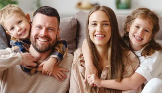 A smiling family happy with their decision to use donor eggs.
