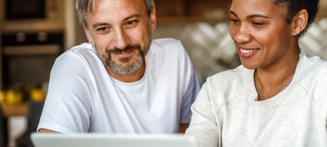 Egg donor recipients looking at Fairfax EggBank's success rates on their laptop.