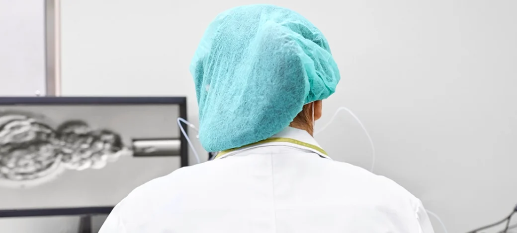 Lab technician examining frozen and fresh donor eggs.