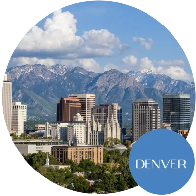 Cityscape of Denver, CO with mountains in the background. Become an egg donor in Colorado today!