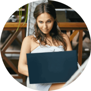 Beautiful woman in hammock with laptop