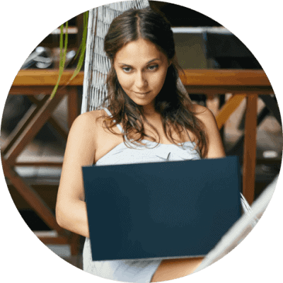 Beautiful woman in hammock with laptop
