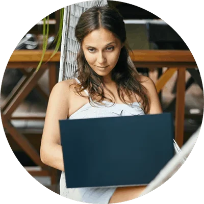 Beautiful woman in hammock with laptop